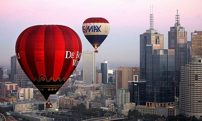 Hot air balloons fly over Melbourne skyline