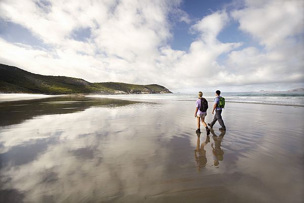 Couple walking along beach in Wilsons Promontory National Park